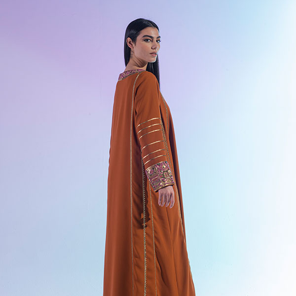 A crepe dress with prominent embroidery inspired by the Hijaz