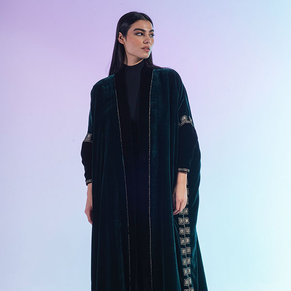 An abaya made of velvet material decorated with hand embroidery, inspired by the Hijaz region