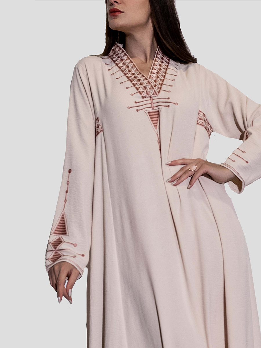 Beige dress from the heritage of the northern region with a V-cut decorated with hand embroidery