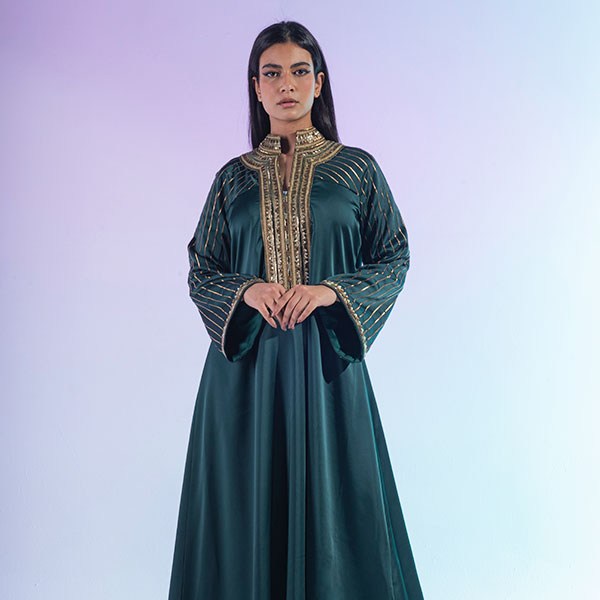 A dress made of crepe satin material with tali embroidery and antique golden sequins, inspired by the Hijaz region