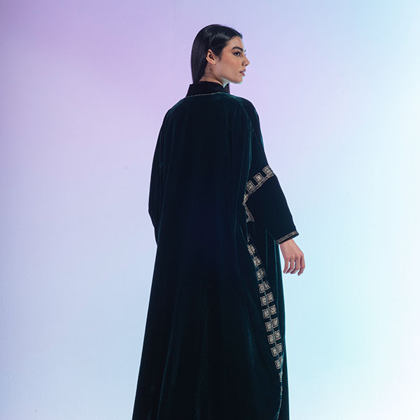 An abaya made of velvet material decorated with hand embroidery, inspired by the Hijaz region