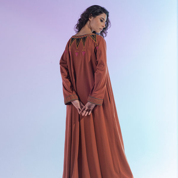 A dress made of crepe material with hand embroidery inspired by the Najdi heritage