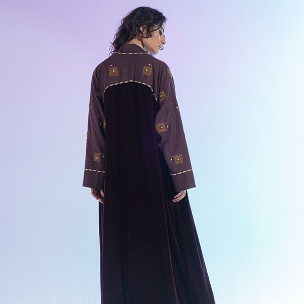 An abaya with a mixture of wool and velvet materials decorated with hand embroidery inspired by the Hijaz region