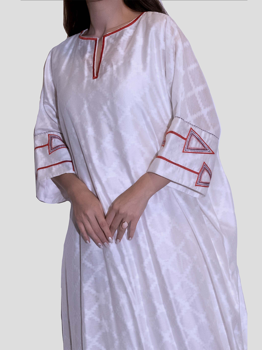 white dress with embroidery on sleeves