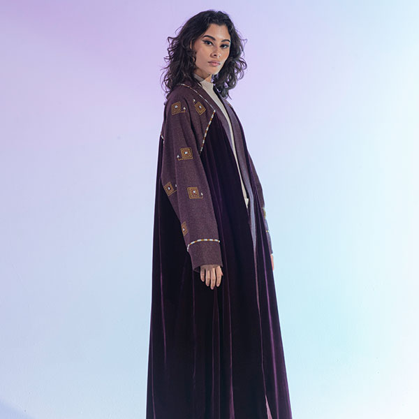 An abaya with a mixture of wool and velvet materials decorated with hand embroidery inspired by the Hijaz region