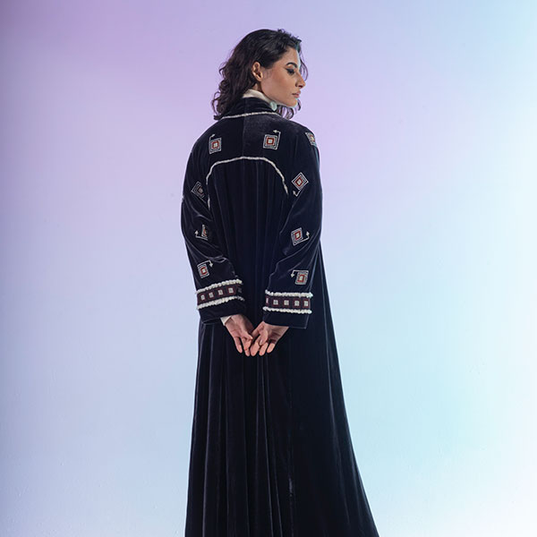 An abaya made of velvet material decorated with hand embroidery, inspired by the Hijaz region