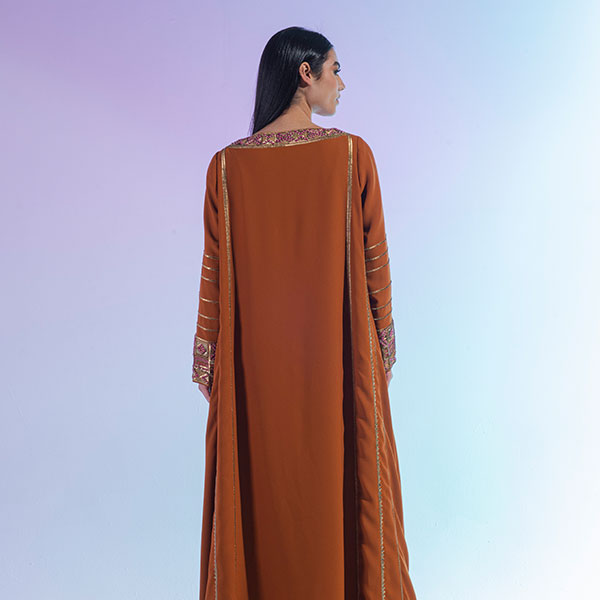 A crepe dress with prominent embroidery inspired by the Hijaz