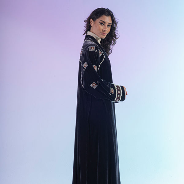 An abaya made of velvet material decorated with hand embroidery, inspired by the Hijaz region